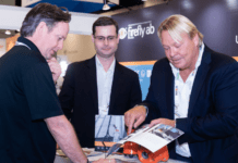 8 Reasons to Exhibit at Tissue World Miami (in 2024) Exhibitor showing products to visitor at Tissue World