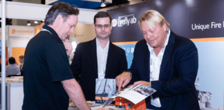 8 Reasons to Exhibit at Tissue World Miami (in 2024) Exhibitor showing products to visitor at Tissue World