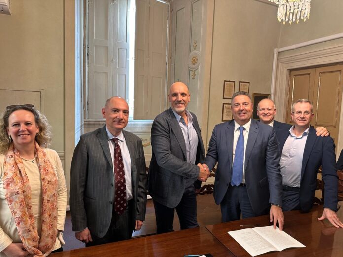 4 ITA Holding acquires Sipack; Sipack founder and Chief Executive Walter Pacioni (left), shakes hands with ITA Holding shareholder Mauro Celli